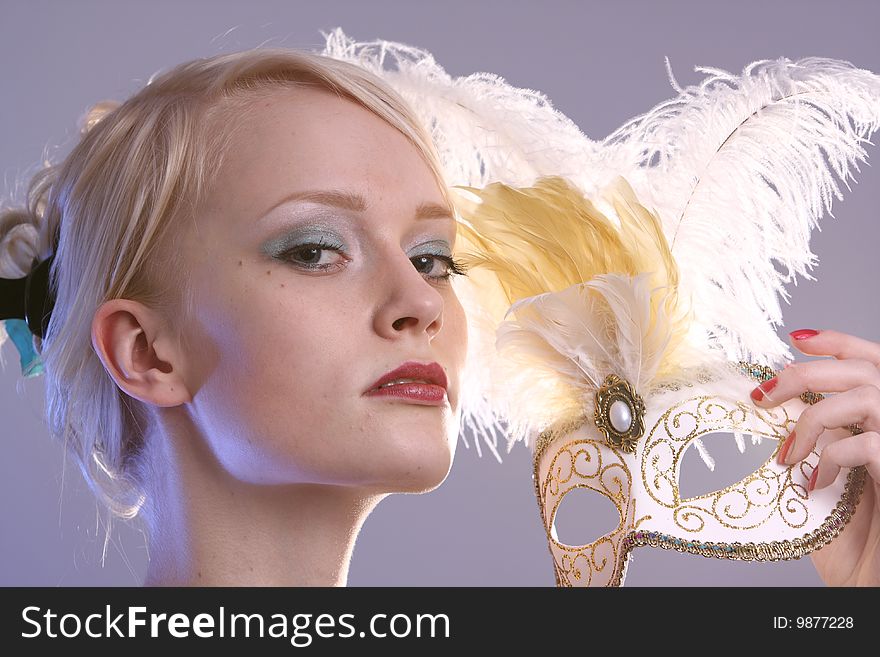 Beautiful young woman with Venetian mask, studio photo. Beautiful young woman with Venetian mask, studio photo