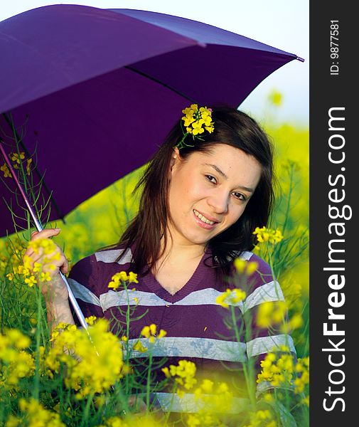 Beautiful girl posing in the field with umbrella. Beautiful girl posing in the field with umbrella