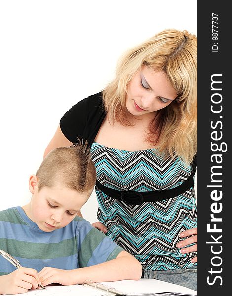 Portrait of mother looking at son doing homework, studio shot. Portrait of mother looking at son doing homework, studio shot