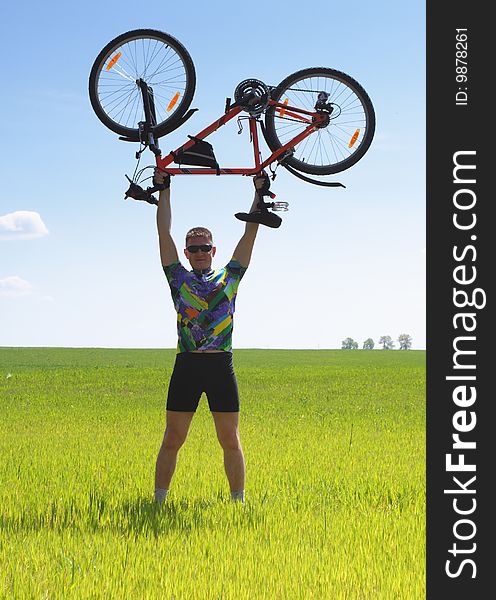 Young Biker tourist relaxation in green field. Young Biker tourist relaxation in green field