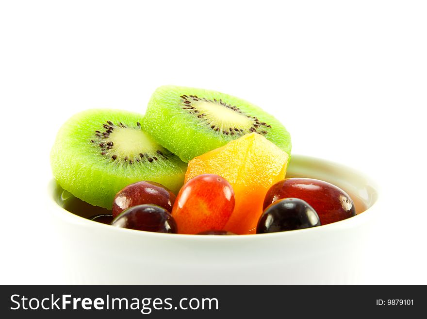 Pot of kiwi, melon and grapes with clipping path on a white background