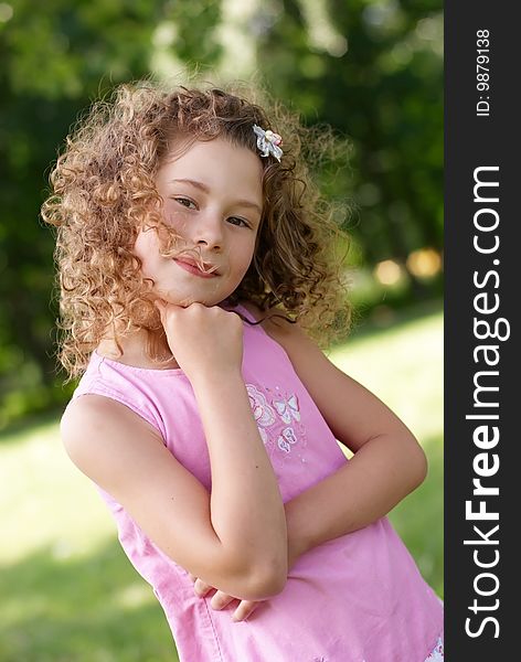 The beatiful smilng girl on green vegetative backgroung. The beatiful smilng girl on green vegetative backgroung