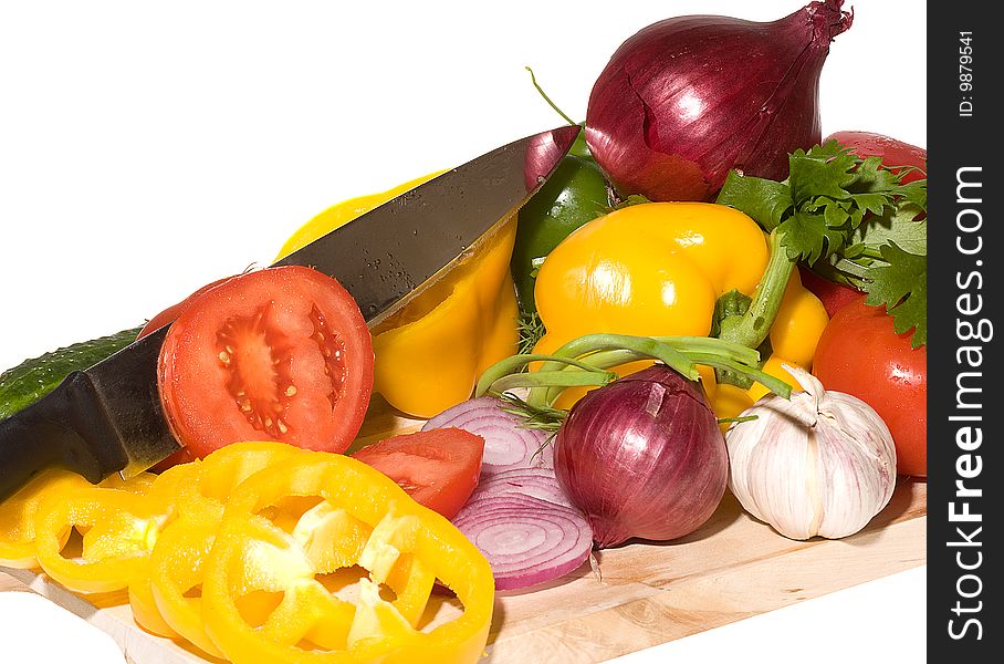 Fresh vegetables with knife on wood cutting board