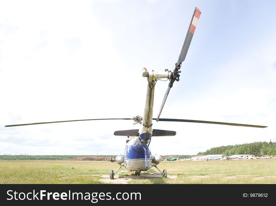 The image of the backpart of the helicopter at the airdrome