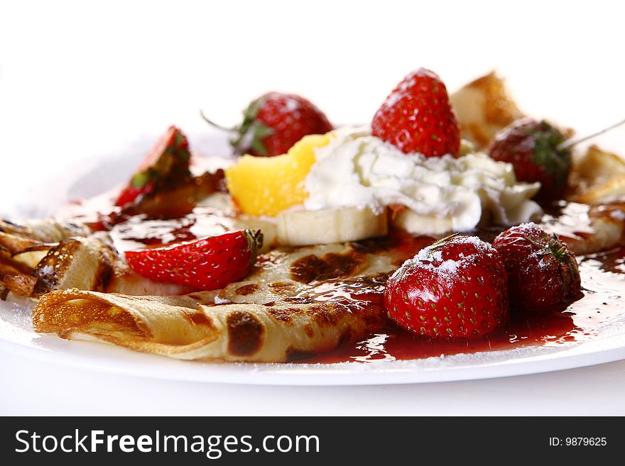 A dessert plate witn pancakes and banan