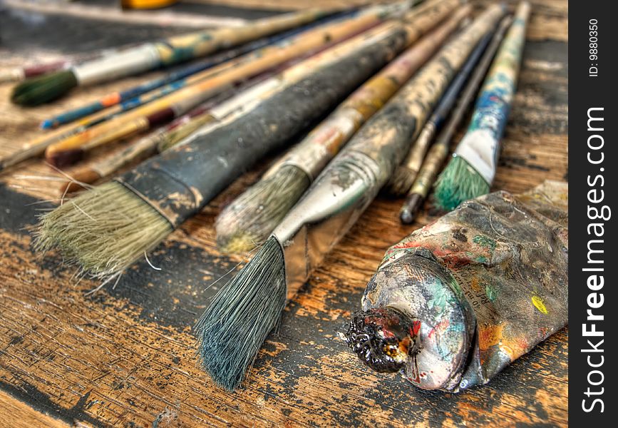 Closeup of used brushes and colors in one art studio. Closeup of used brushes and colors in one art studio.