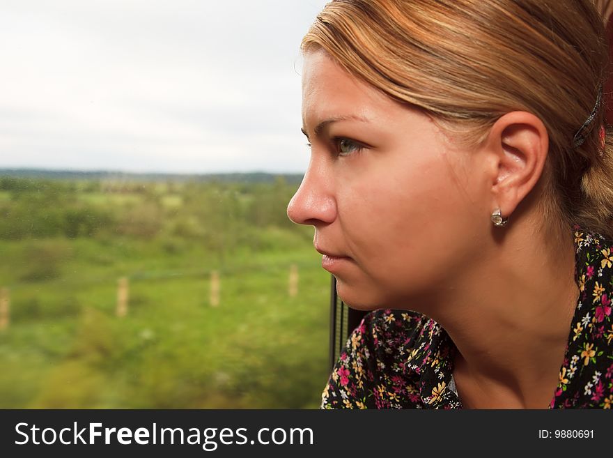 Young Woman Looking In The Window Of A Train