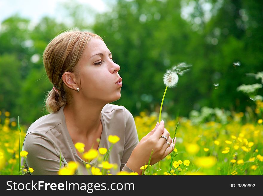 The Girl Blows On A Dandelion