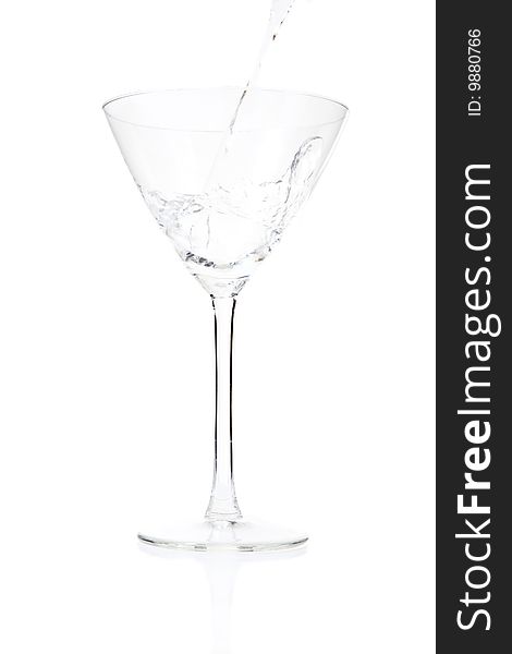 Pouring cocktail glass with alcohol