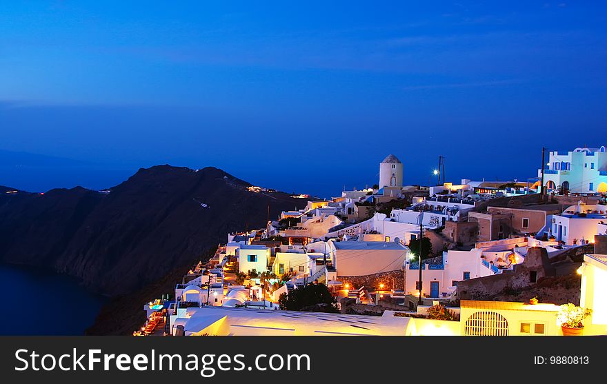 Image shows the village at dusk, on the beautiful island of Santorini, Greece. Image shows the village at dusk, on the beautiful island of Santorini, Greece