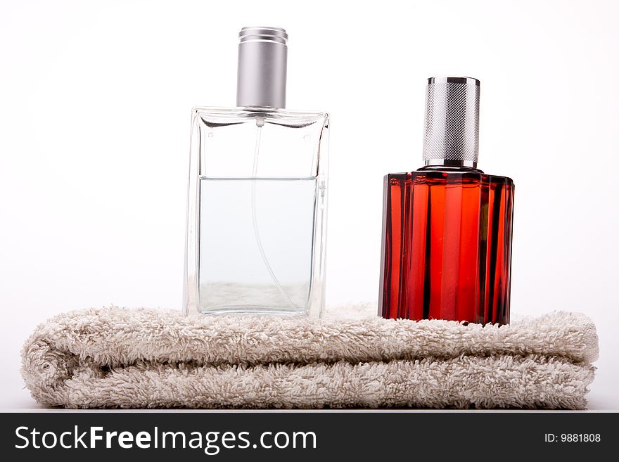 Perfumes on a towel with white background. Perfumes on a towel with white background.