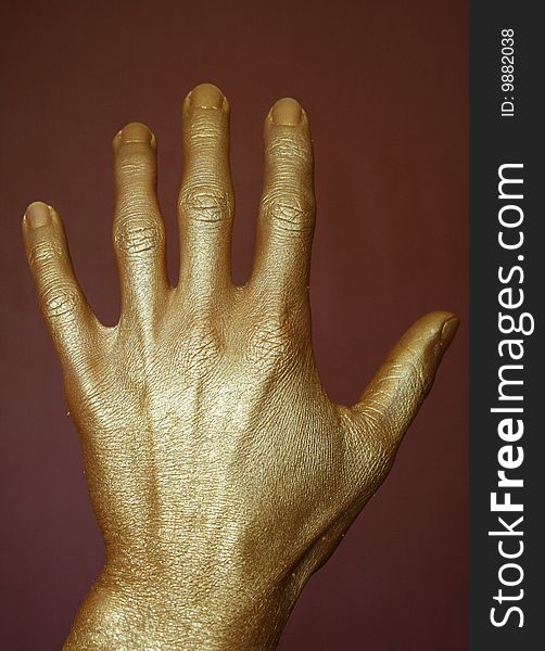 Gold hand on a dark background