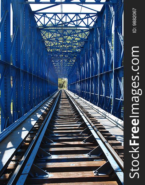 A railway on a blue iron bridge. A railway on a blue iron bridge