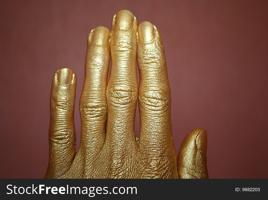 Gold hand on a dark background