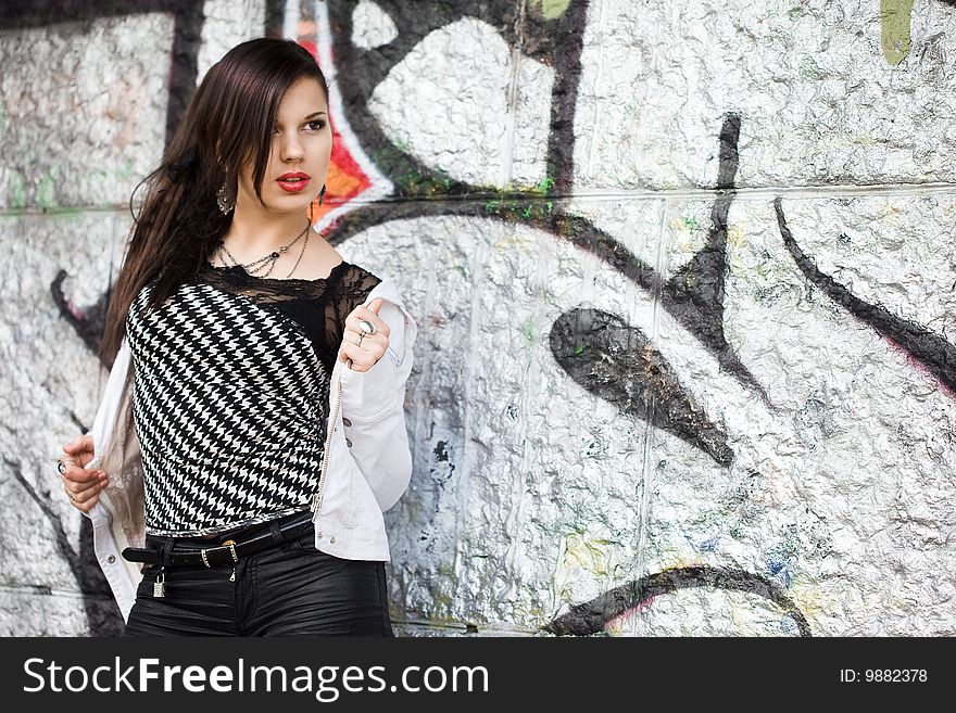 Girl near the wall with graffiti