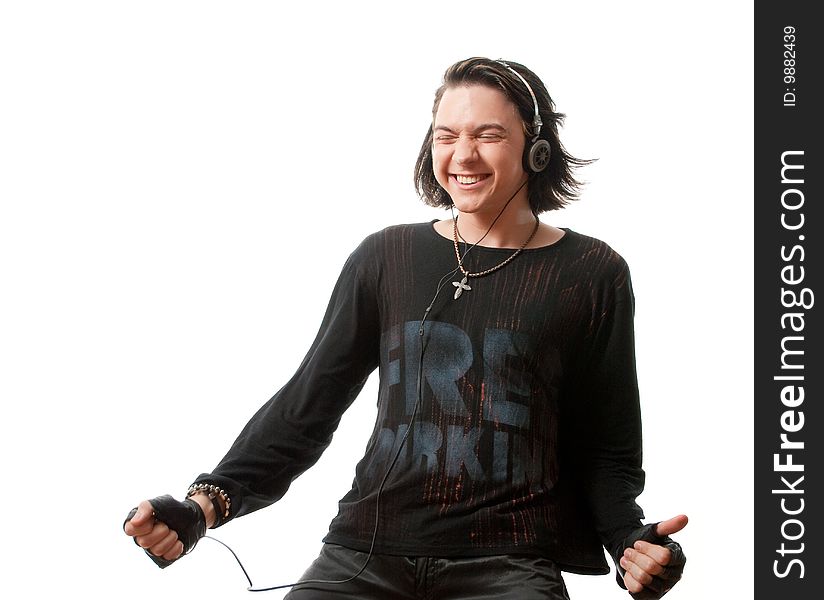 Young man listens to music in ear-phones. Isolated over white in studio