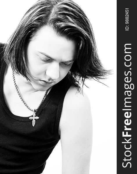 Black-and-white stylish studio portrait of long-haired young guy. Black-and-white stylish studio portrait of long-haired young guy