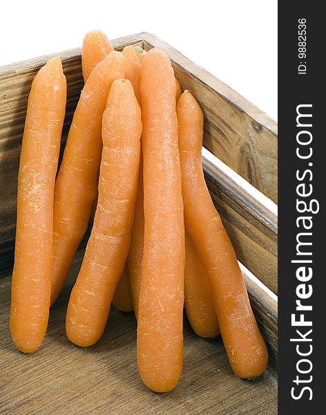 Several carrots piled in a wooden box. Several carrots piled in a wooden box.