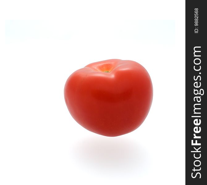 A tomato isolated against a white background.