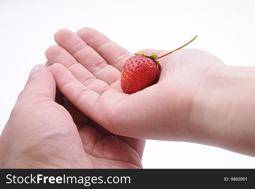 Hands of a couple with strawberry. Hands of a couple with strawberry