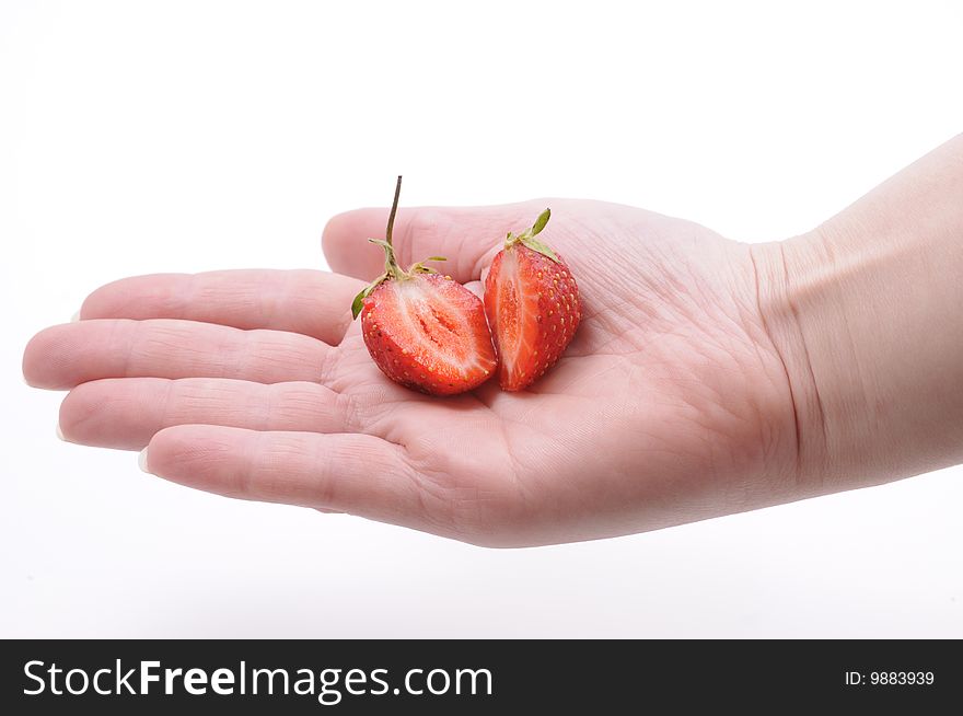 Girls hand with strawberry on white background. Girls hand with strawberry on white background