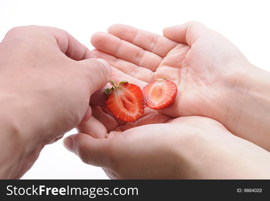Hands of a couple with strawberry. Hands of a couple with strawberry
