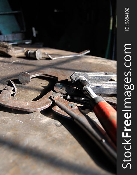 A low angle of tools from a machine shop of clamp and vice. A low angle of tools from a machine shop of clamp and vice