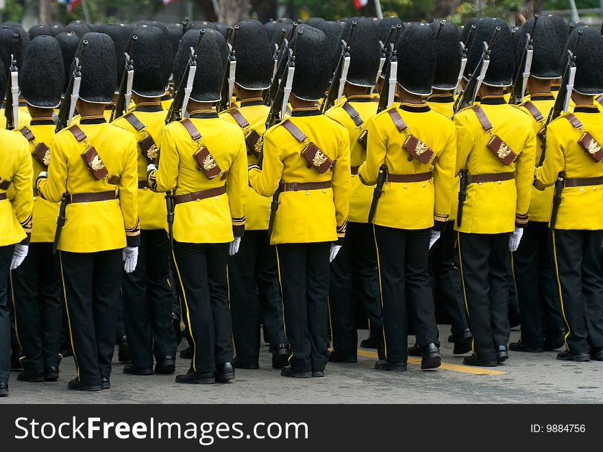 Thai soldiers parading at a street in Bangkok in yellow and black parade uniforms. Thai soldiers parading at a street in Bangkok in yellow and black parade uniforms.