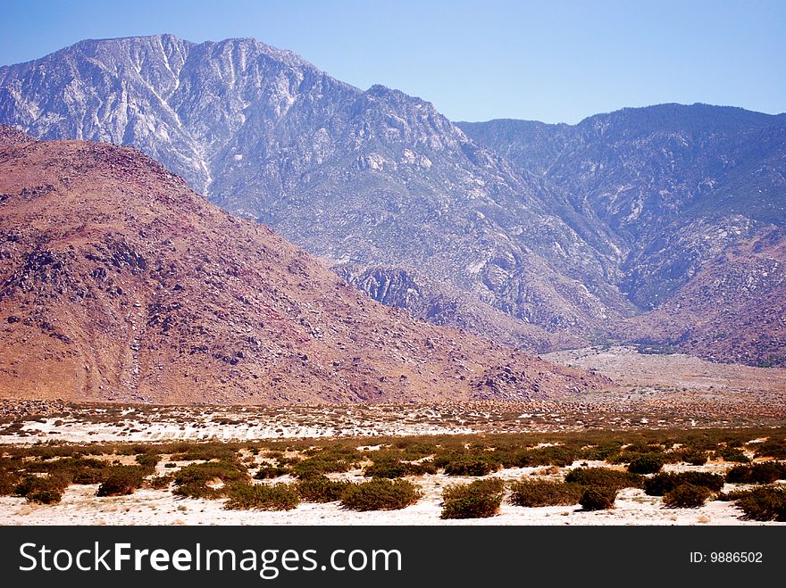 The California desert stretches in front of beautiful mountains. The California desert stretches in front of beautiful mountains
