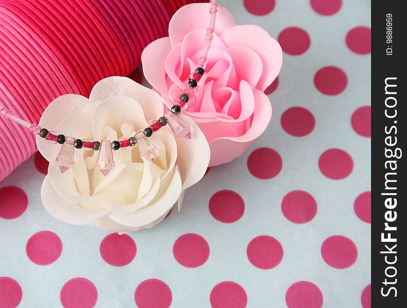 Pink hairbands and other accessories on a polka dot background. Pink hairbands and other accessories on a polka dot background