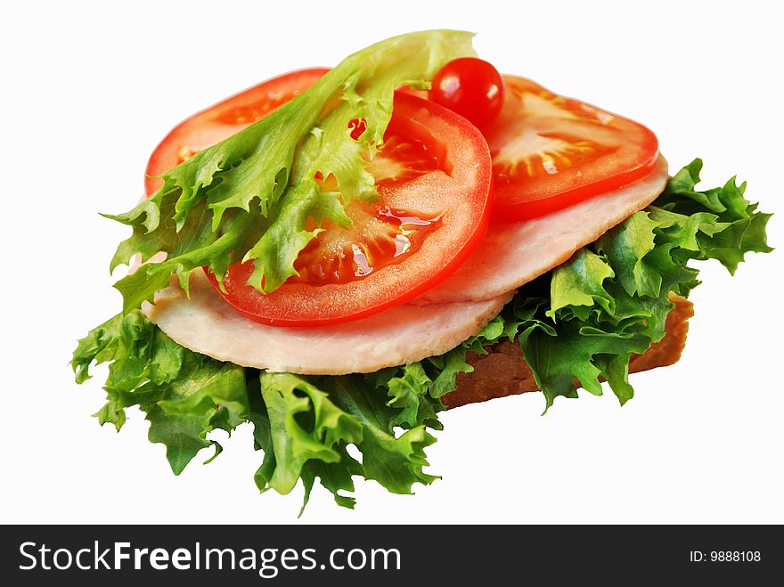 Sandwich with ham and sliced tomatoes isolated over white