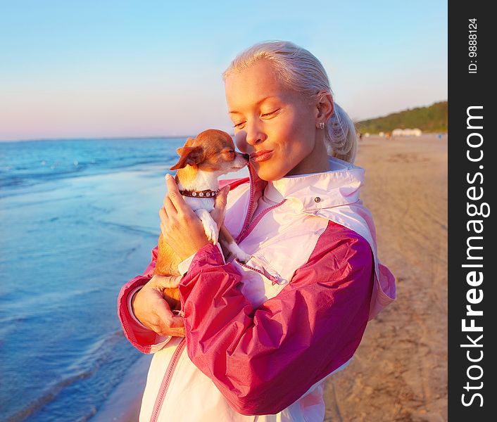 Young woman with her dog on a beach. Young woman with her dog on a beach