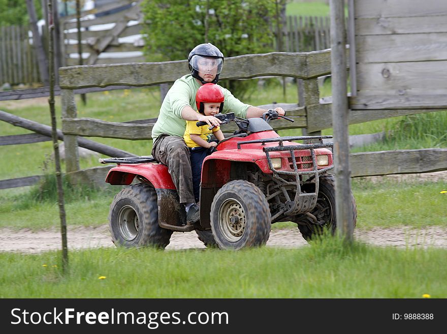 Dad With Son Riding A Quad