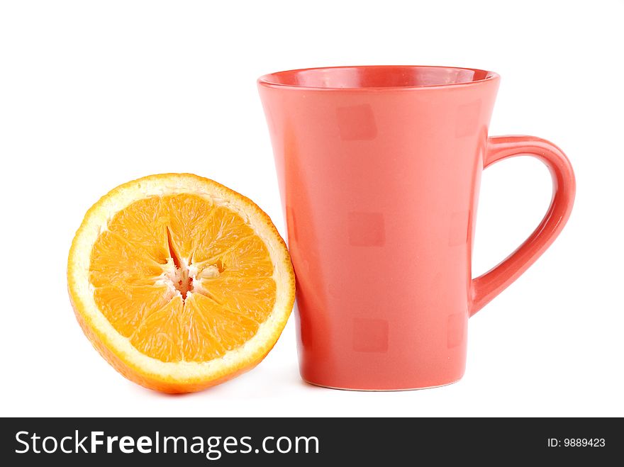 Colour cup and the fresh cut orange near to it. Colour cup and the fresh cut orange near to it.