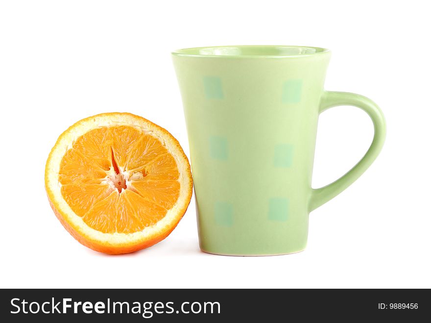 Colour cup and the fresh cut orange near to it. Colour cup and the fresh cut orange near to it.