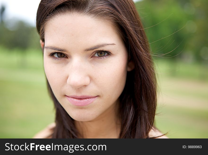 A Fresh Faced Girl With a beautiful face and green background. A Fresh Faced Girl With a beautiful face and green background