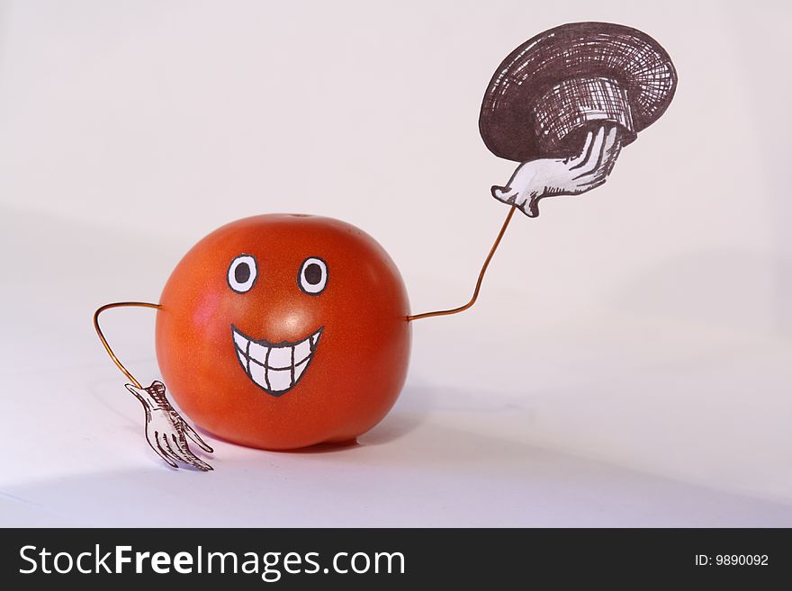 Tomato with a hat on a white background. Tomato with a hat on a white background