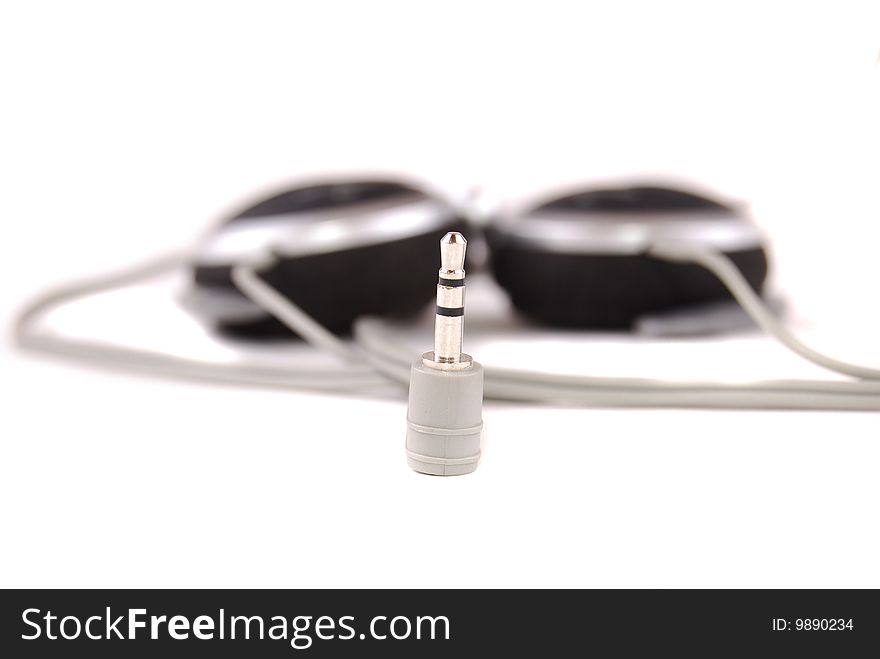 Small easy ear-phones of silvery colour with a cable and the plug.