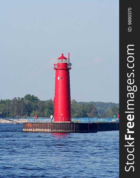 Image of a red lighthouse on a summer day