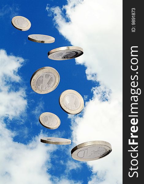 One euro coin flying on blue sky background. Object with clipping path. One euro coin flying on blue sky background. Object with clipping path