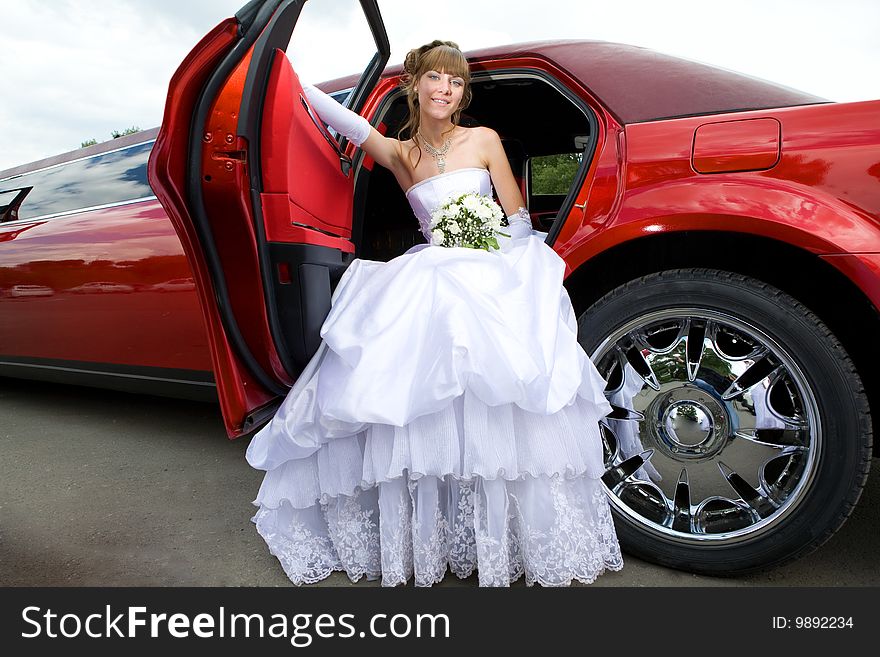 Beauty bride woman with limousine outdoor