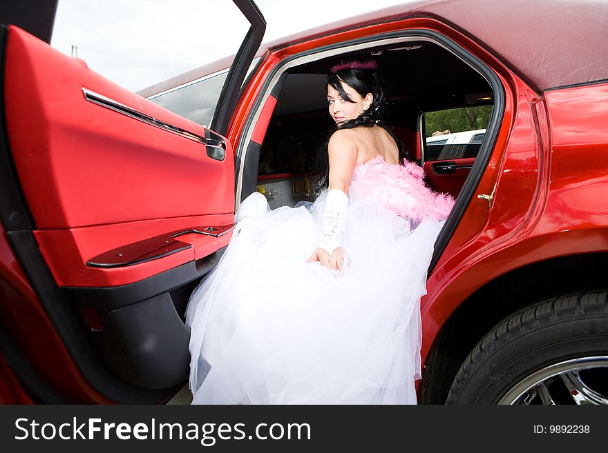 Beauty bride woman with limousine outdoor