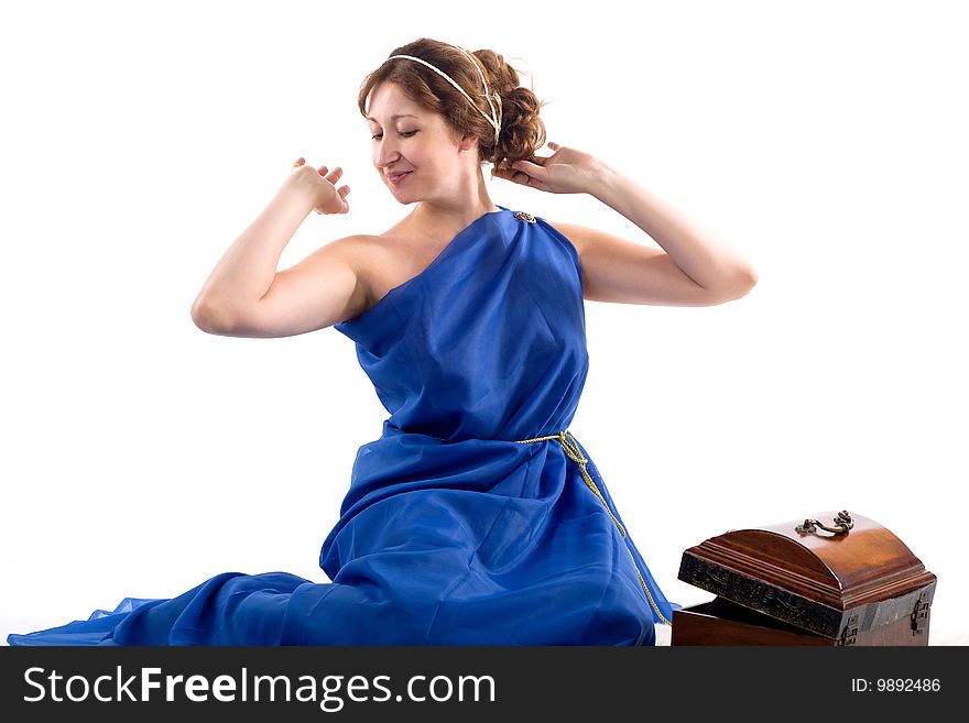 Lady in blue antique dress opening box on white background. Lady in blue antique dress opening box on white background