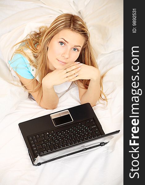 Young woman having a rest with her laptop. Young woman having a rest with her laptop.