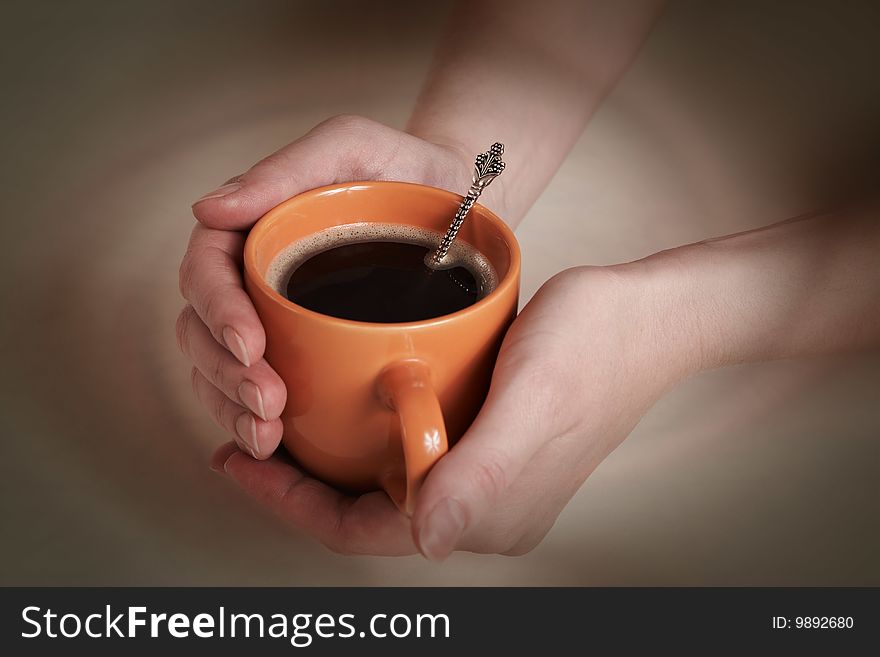 Cup of coffee in hands. Cup of coffee in hands
