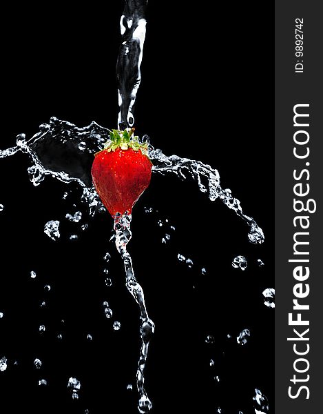 Strawberry in water on a black background
