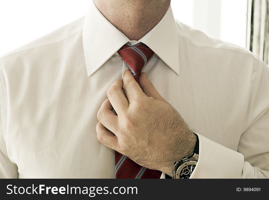 Businessman Adjusting Tie