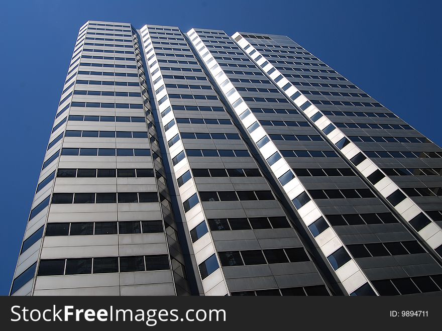 Nice view of a modern office building on a clear blue sky. Nice view of a modern office building on a clear blue sky