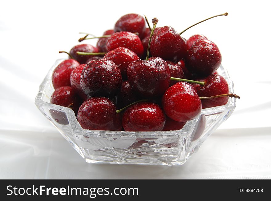 Freshly picked cherries in a crystal bowl