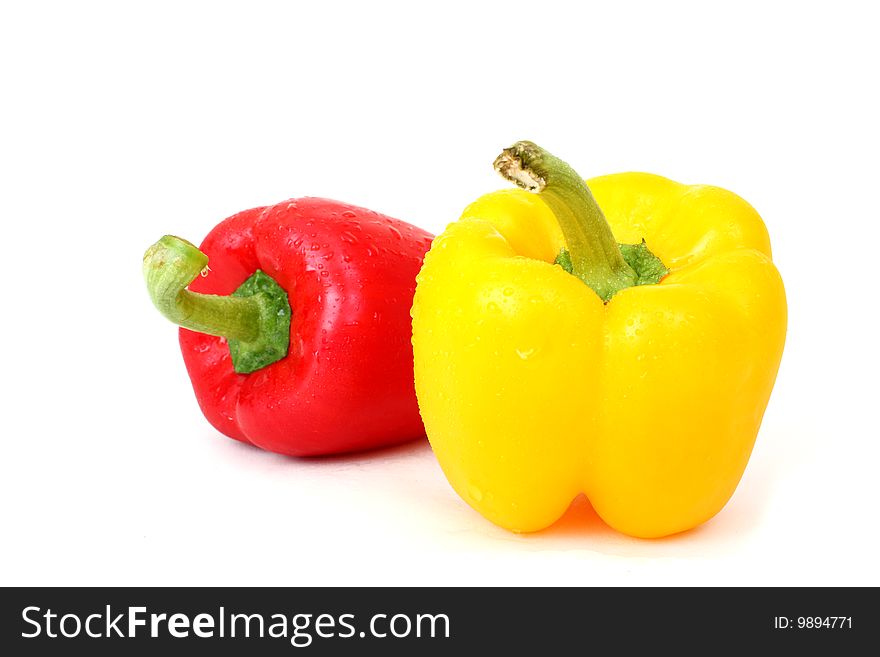 Two fresh paprika (red and yellow) photographed on white background. Two fresh paprika (red and yellow) photographed on white background